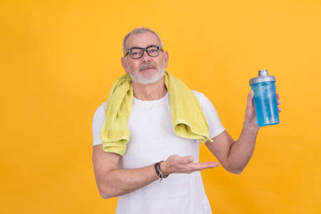 Middle-aged athlete man showing healthy food. diet and eating concept