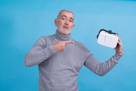 man with 3d virtual reality glasses isolated on blue backgroundの写真素材