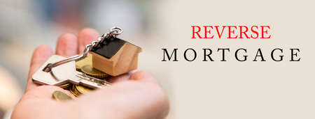 Woman holding house key in hand. Mortgage loan approval home loan and insurance concept.の写真素材