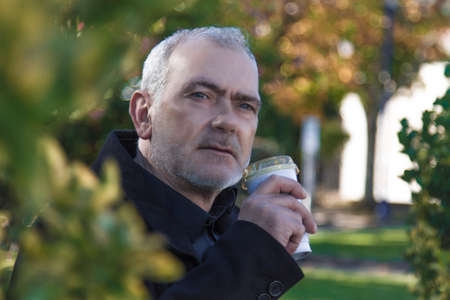 relaxed man having a coffee in the parkの写真素材