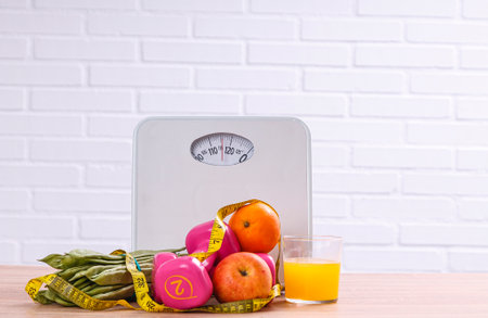 vegetarian food, dumbbells, tape measure and scale, concept of diet and healthの写真素材