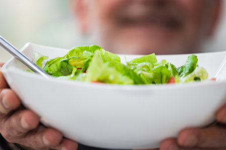 man holding bowl of salad. vegan diet conceptの写真素材