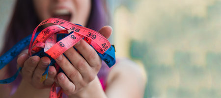 woman holding colored tape measures