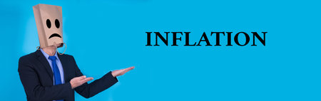 businessman with inflation concept on blue backgroundの写真素材
