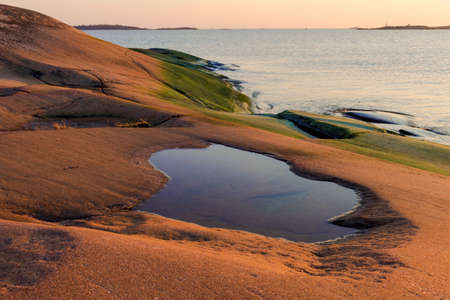 Evening atmosphere on the rocks in the baltic seaの写真素材