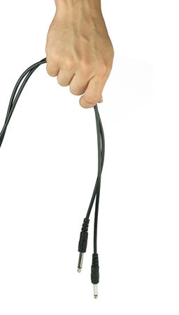 Hand with two audio cable isolated on white backgroundの写真素材