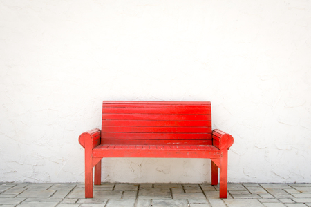 Red armchair a white wall and grey floorの写真素材