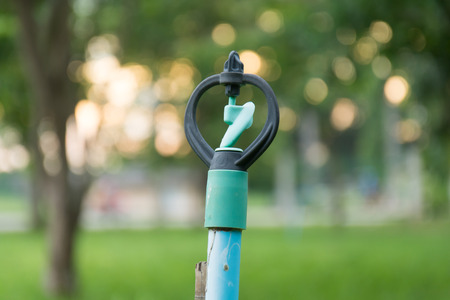 sprinklers watering and bokeh sunsetの写真素材