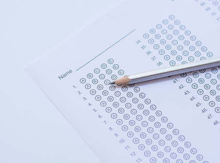Standardized test form with answers bubbled in and a pencilの写真素材