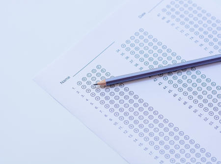 Standardized test form with answers bubbled in and a pencilの写真素材
