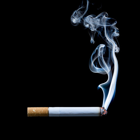 smoking cigarette on black backgroundの写真素材