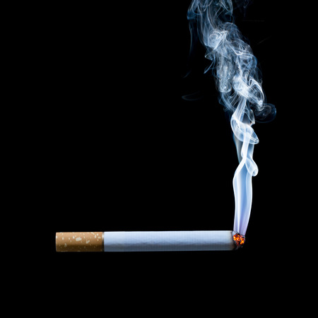 smoking cigarette on black backgroundの写真素材