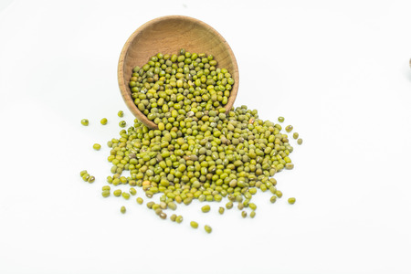 Mung beans in wood bowl isolated on white backgroundの写真素材