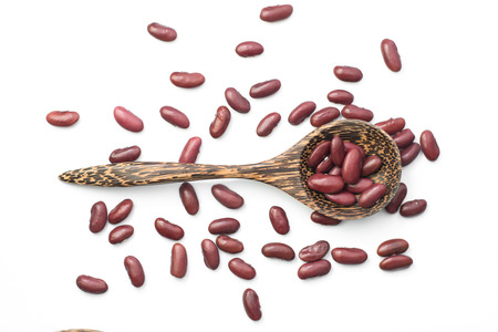 Red kidney beans on a wooden spoon isolate on whiteの写真素材