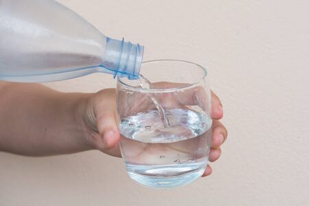bottle of water Pouring water into a glass