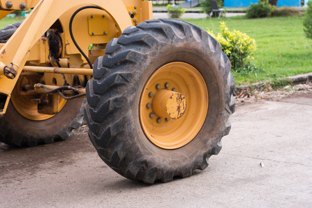 big wheel on yellow tractorの写真素材