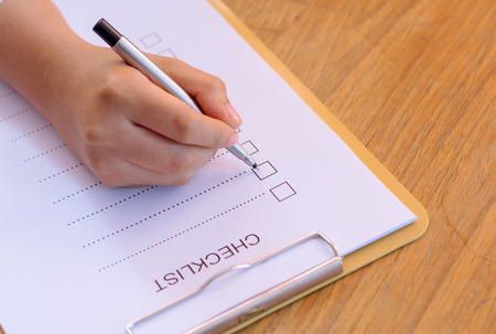 image of businessfemale preparing checklist at office desk
