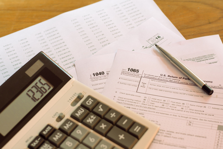 US tax form with pen and calculator selective focus / taxation conceptの写真素材