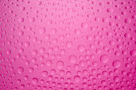 Water drops pink background. Water drops on glass backgroundの写真素材