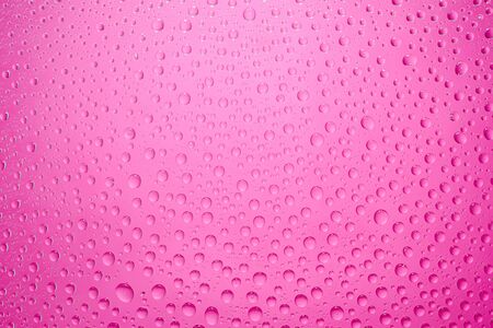 Water drops pink background. Water drops on glass backgroundの写真素材