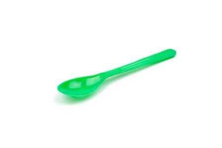 Green plastic spoon isolated on white backgroundの写真素材