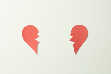 Red paper broken heart on white backgroundの写真素材