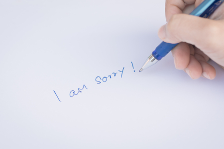 say sorry with a text message on paper and penの写真素材
