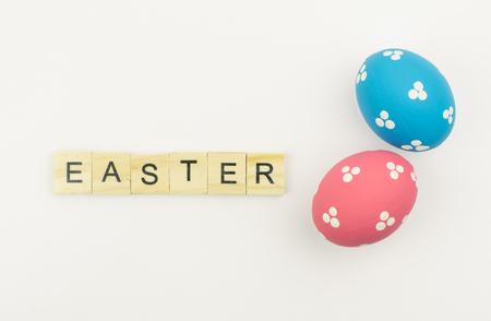 Text wooden blocks spelling the word happy easter on white backgroundの写真素材