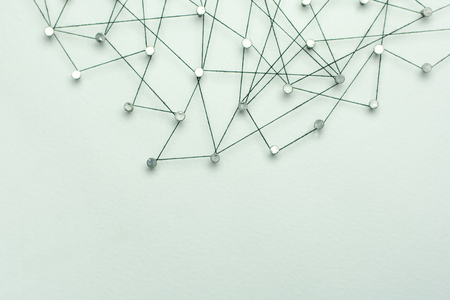 Linking entities. Network, networking, social media, internet communication abstract. A small network connected to a larger network. in paper linked together by cotton with a black tintの写真素材