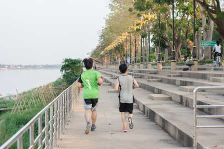 Two young athletes jogging. Running Riversideの写真素材