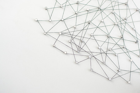 Linking entities. Network, networking, social media, internet communication abstract. A small network connected to a larger network. in paper linked together by cotton with a black tintの写真素材
