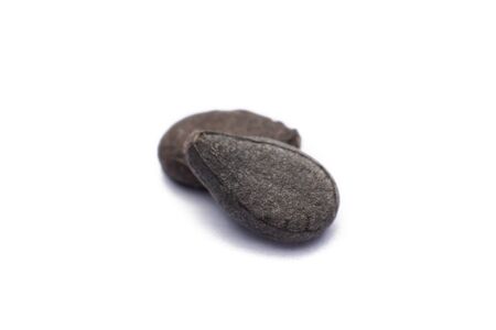 Close up pile of black sesame seeds isolated on white backgroundの写真素材