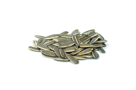 sunflower seeds pile isolated on white backgroundの写真素材