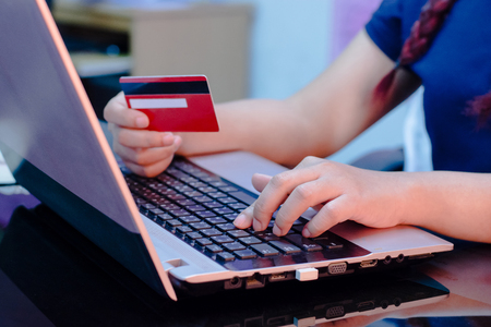 woman hand holding credit card and using laptop computer. Online shopping conceptの写真素材