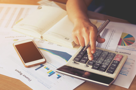 woman hand using calculator and writing make note with calculate,business conceptの写真素材