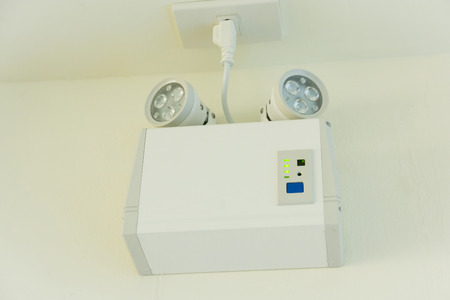 emergency lights with two lamps on the wallの写真素材