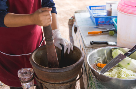 making papaya salad in a mortar, som tam, thai street food,の写真素材