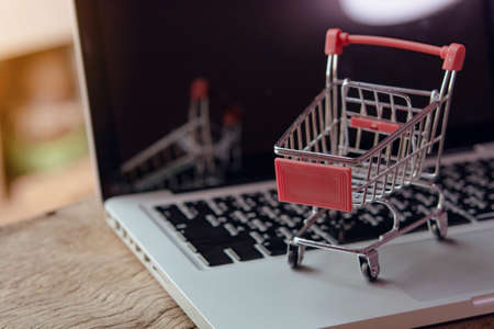 Shopping online concept - Empty shopping cart or trolley on a laptop keyboard. Shopping service on The online web. offers home delivery.の写真素材