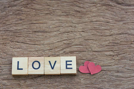 Text wooden blocks spelling the word love on wooden backgroundの写真素材