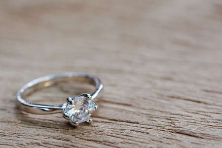 Diamond ring, wedding ring on plank wooden with copy spaceの写真素材