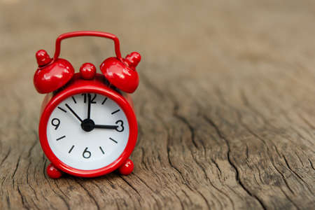 Red alarm clock on wood background with copy spaceの写真素材