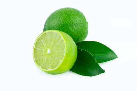 Lime with slices half and leaves isolated on white background. Green citrus fruit.の写真素材