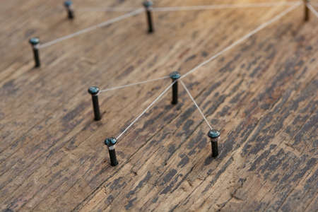 Connecting networks concept - network connected with yarn white on Plank wood with copy space....