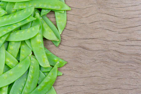 Sugar Pea, Snow peas on plank wooden backgroundの写真素材