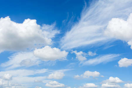 Cirrus and cumulus clouds on blue sky background.