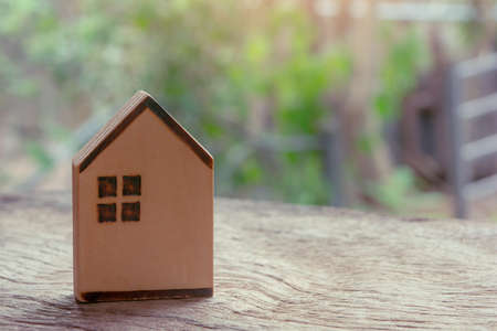 wooden house on wooden table. Property investment and house mortgage financial concept.の写真素材