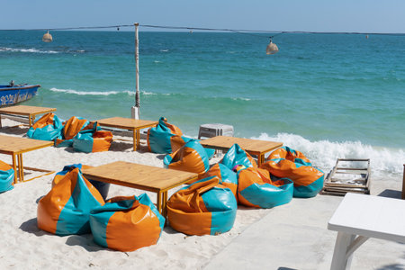Bean bags and table on the beach.の写真素材