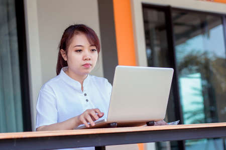 Asian woman working laptop. A woman working on a laptop at homeの写真素材