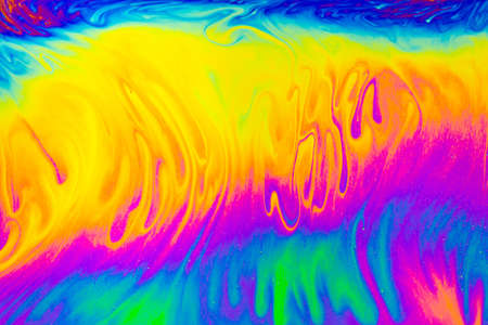 Rainbow colors. Psychedelic multi colored patterns background. Photo macro shot of soap bubblesの写真素材