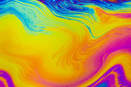 Rainbow colors. Psychedelic multi colored patterns background. Photo macro shot of soap bubblesの写真素材
